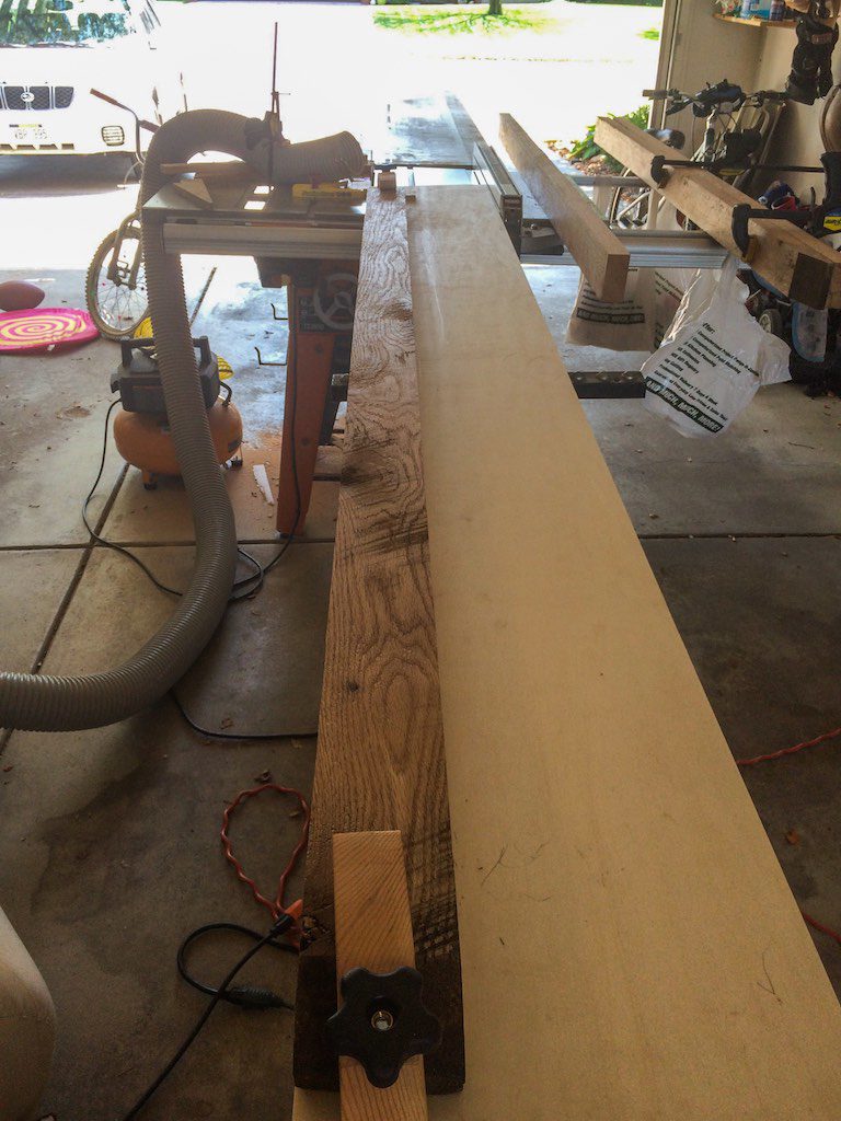 photo of a piece of oak on my straightening jig about to be run through the table saw