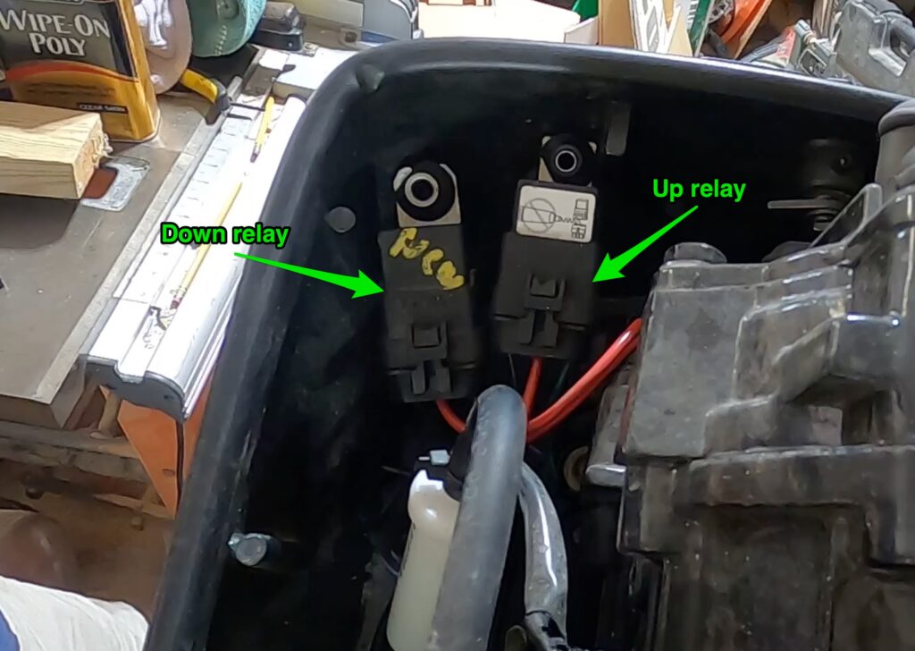 photo showing general location of the up and down trim relays on a typical outboard boat motor.